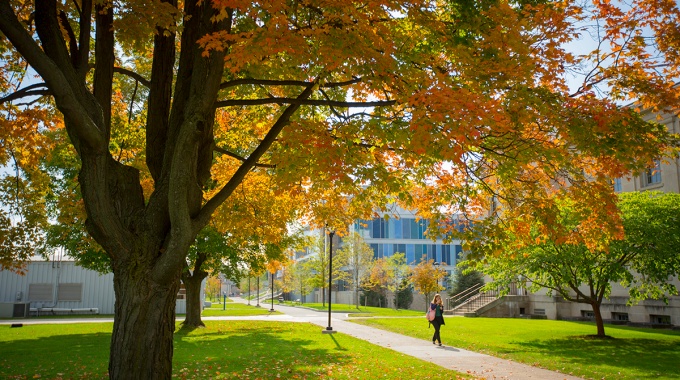 Student walking on UB South Campus. 