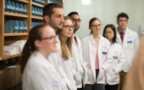 UB pharmacy students standing together in a lab. 