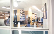 Zoom image: PSI students exploring the Model Pharmacy. 