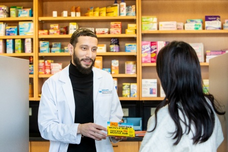 SPPS student dispensing medication in Model Pharmacy. 