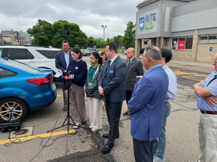 SPPS students and faculty discussing community impact of pharmacy closures at press conference. 