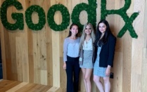 UB SPPS students standing together by GoodRx sign.